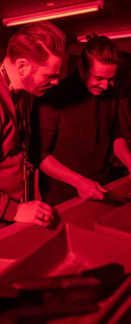 lecturer and student looking at images in dark room
